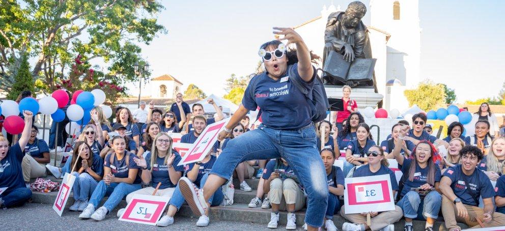 Wowie student cheering in front of group of students during Farewell BBQ